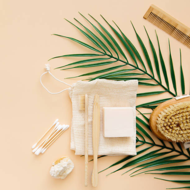 istock Eco friendly bathroom accessories: bamboo toothbrushes, bamboo ear sticks, organic soap, reusable cotton bags on a beige background. The concept of caring for the environment. 1365633700