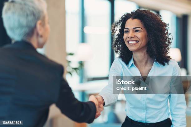 Smiling Businesswoman Greeting A Colleague On A Meeting Stock Photo - Download Image Now