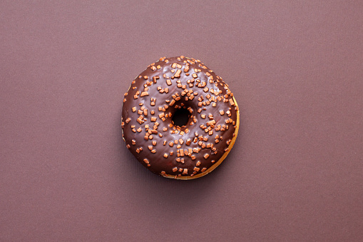 chocolate doughnut isolated on brown background
