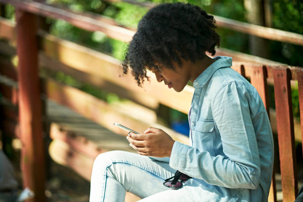 istock Mid 20s woman checking smart phone during weekend getaway 1365639239