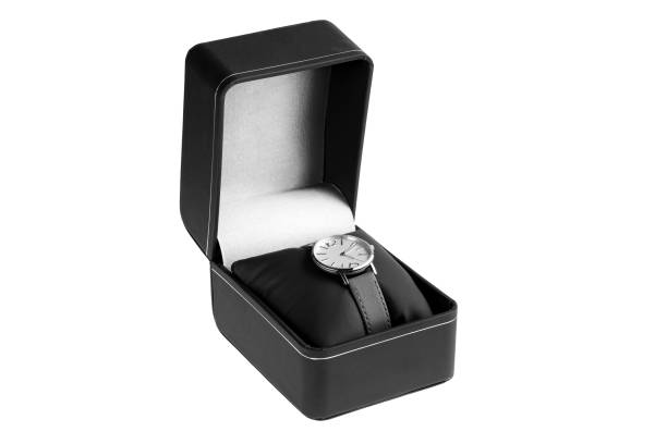 istock gift wrist watch with round dial and minimalist design with leather strap, unisex luxury accessory worn on black cushion packed in black leather box for clock, object on white background, nobody. 1365639455