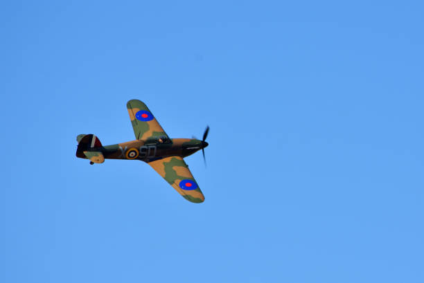 Low passing by of a Historical Spitfire in silhouette