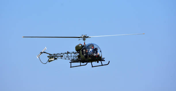 Bell 47G-4A G - MASH  Helicopter in flight Little  Gransden,  Cambridgeshire, England - August 25, 2019: Vintage  Bell 47G-4A G - MASH  Helicopter in flight television show stock pictures, royalty-free photos & images