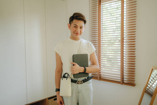 istock Asian non-binary gender person applying makeup in dressing room. 1365642027
