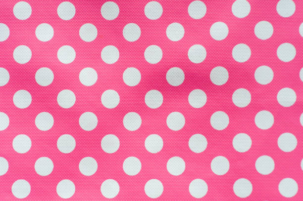 istock Fresh pink background with white sopts. 1365642084