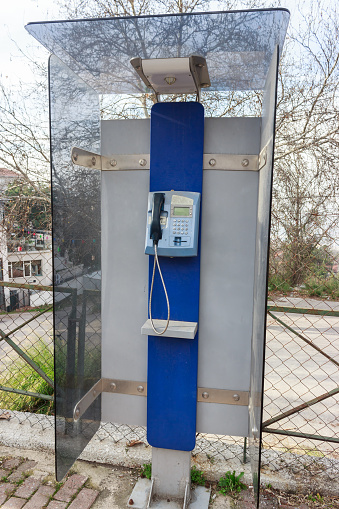 Blue old phone booth for public telecommunication.