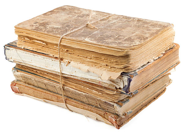 istock Stack of old books tied with rope isolated on white 136564559