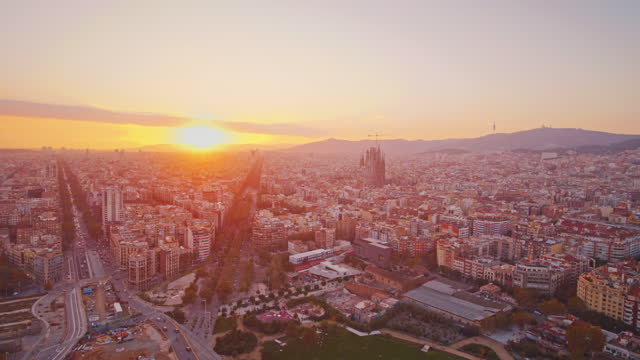 Aerial view of a glass skyscraper in Barcelona city at sunset