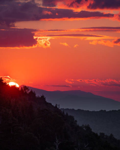 istock The sky lights up red as the sun sets in the mountains 1365646955