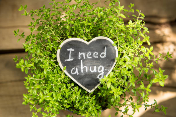 istock I need a hug hand drawing phrase on a heart, Sharing a Hug concept 1365648534