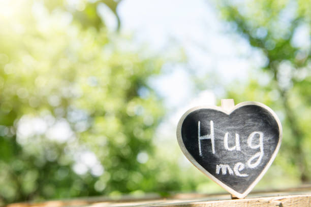 istock Hug me hand drawing phrase on a heart, Sharing a Hug concept 1365648546