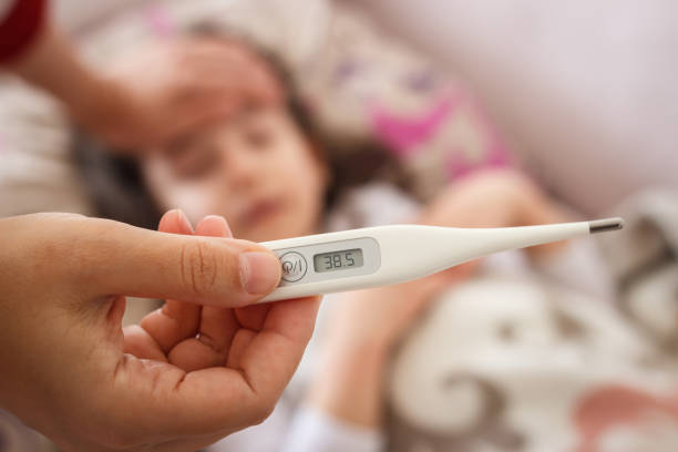 istock The mother is checking her daughter's fever with thermometer. 1365649409