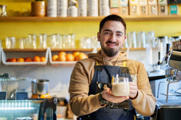 istock Waiter serving hot tea with milk 1365649530