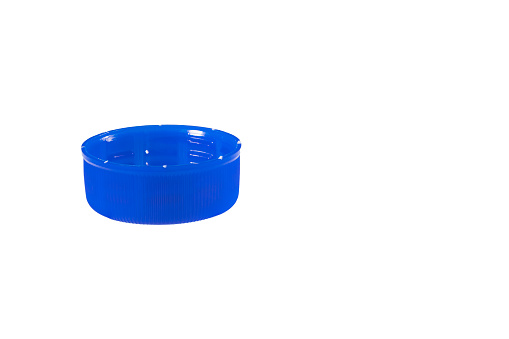 Close up side view of a blue plastic cap isolated on white background.