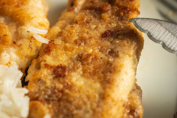 istock fried breaded chicken breast fillet and basmati rice 1365650069