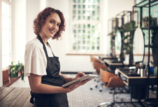 istock Shot of a hairstylist using a digital tablet at work 1365651516