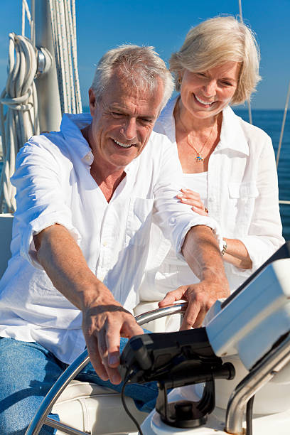 istock Happy Senior Couple Using SatNav GPS on a Sail Boat 136565632