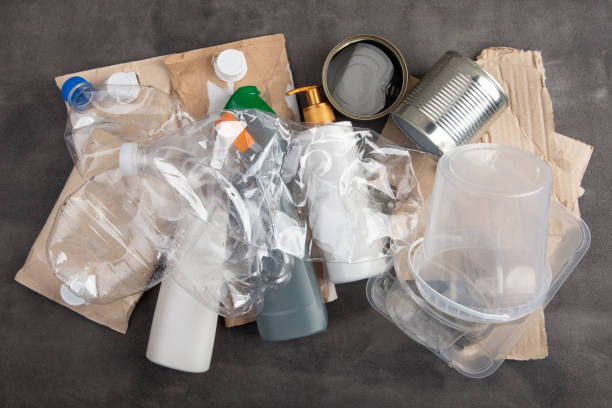 istock Recycling and ecology concept. Sorting household waste - plastic, paper, metal, captured from above, flat lay. Grey concrete background 1365657193
