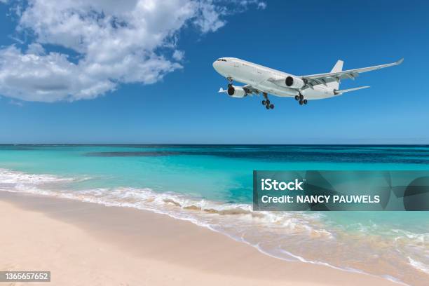 Airplane Landing Over Beautiful Beach Stock Photo - Download Image Now - Airplane, Beach, Flying