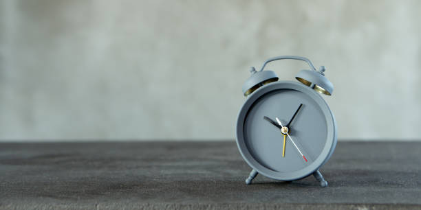 istock Vintage alarm clock on wooden table on grey background, copy space for text 1365658402