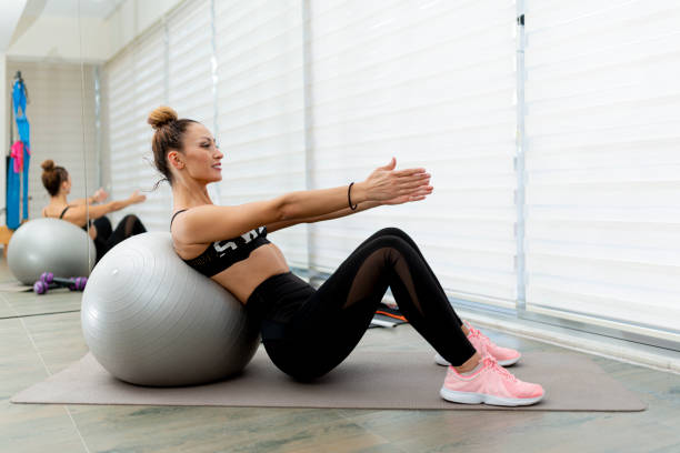 istock Fitness trainer exercising on a plate ball. 1365659194