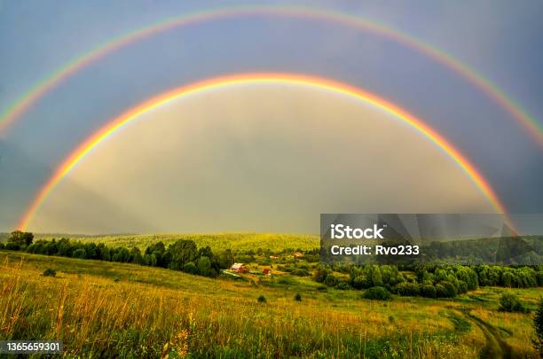 Full Arc Of Double Rainbow Over Summer Evening Rural Landscape Panoramic View Stock Photo - Download Image Now