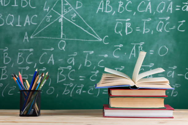 istock Education concept - books on the desk in the auditorium 1365659337