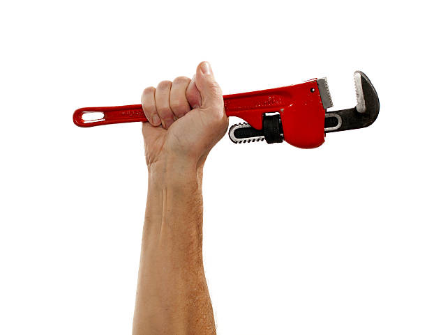 senior uomo che tiene una grande chiave - adjustable wrench wrench clipping path red foto e immagini stock