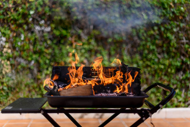 istock Barbecue grill with big fire flame in a garden on open air 1365661933