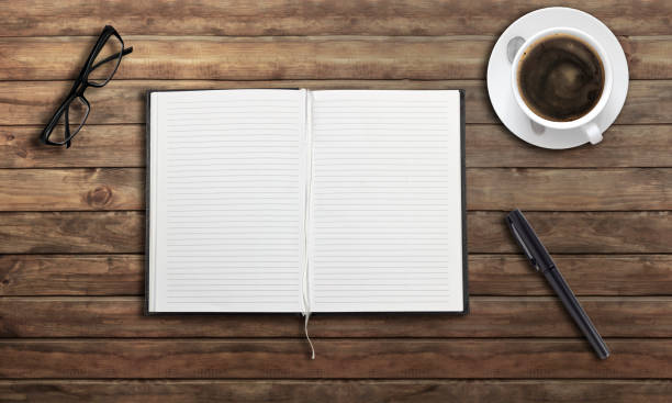 istock open notepad, coffee cup, pen, on the table Business, planning, education, morning life, work at home, concept Top view Flat mockup 1365665234