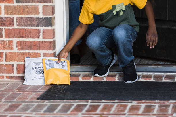 istock Boy receives delivered packages 1365666351