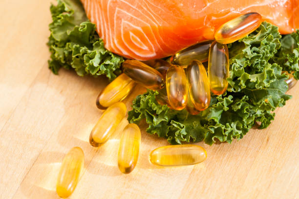 Salmon fish with medicine fish oil pills stock photo