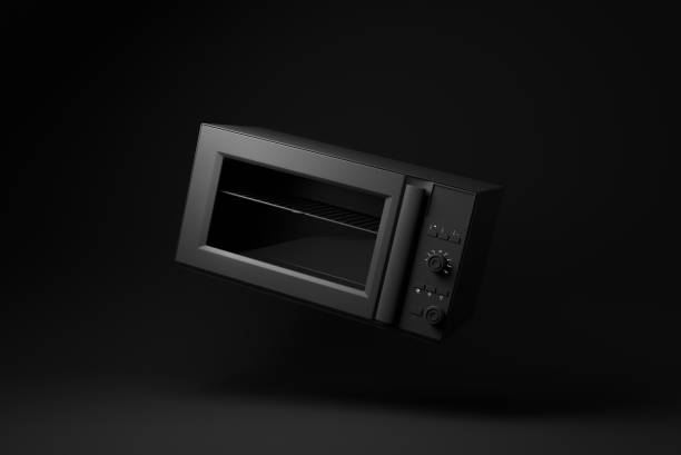 istock Black Microwave Oven floating on black background. minimal concept idea. monochrome. 3d render. 1365668339