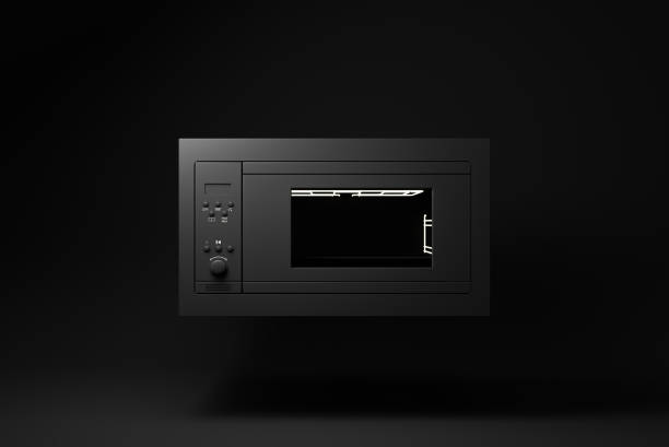 istock Black Microwave Oven floating on black background. minimal concept idea. monochrome. 3d render. 1365668341