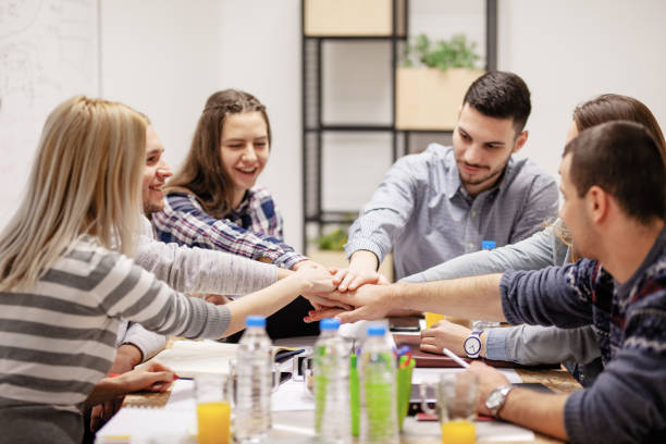 istock group of young creatives, shaking hands 1365672792