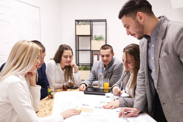 istock group of successful young architects and businessmen in modern workplace, having a creative meeting. 1365672825