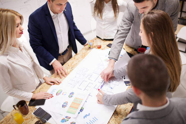 istock group of successful young architects and businessmen in modern workplace, having a creative meeting. 1365672854