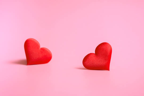 istock Composition for Valentine's Day. On a green background, red hearts closeup with copy space 1365673612