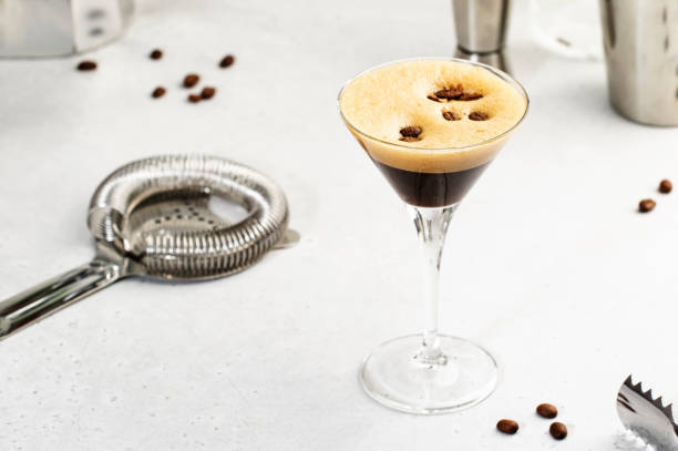 istock Espresso martini alcoholic cocktail with vodka, coffee liqueur, syrup and ice, white background, bar tools, copy space 1365675261