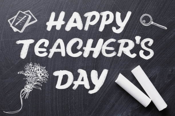 istock Text Happy Teacher's Day with drawings and chalk on blackboard, top view. Greeting card design 1365676801