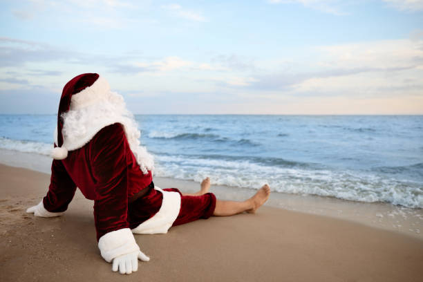 istock Santa Claus relaxing on beach, space for text. Christmas vacation 1365676820