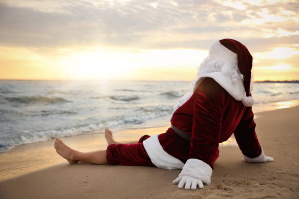 Santa Claus relaxing on beach, space for text. Christmas vacation