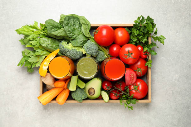 istock Delicious vegetable juices and fresh ingredients on light grey table, top view 1365678099
