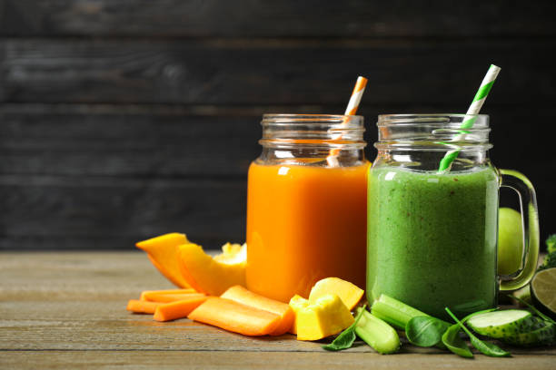 istock Delicious vegetable juices and fresh ingredients on wooden table. Space for text 1365678100
