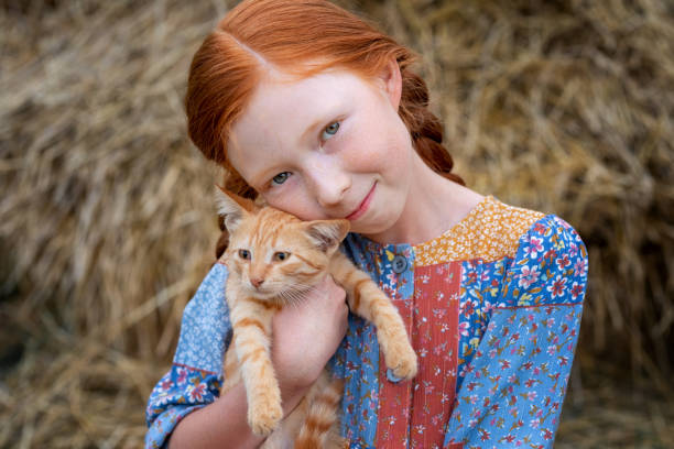 istock redhead girl and red kitten 1365678721