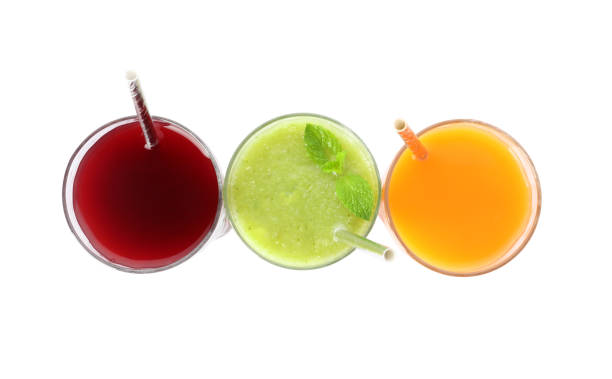 Delicious colorful juices in glasses isolated on white, top view Delicious colorful juices in glasses isolated on white, top view freshly squeezed stock pictures, royalty-free photos & images