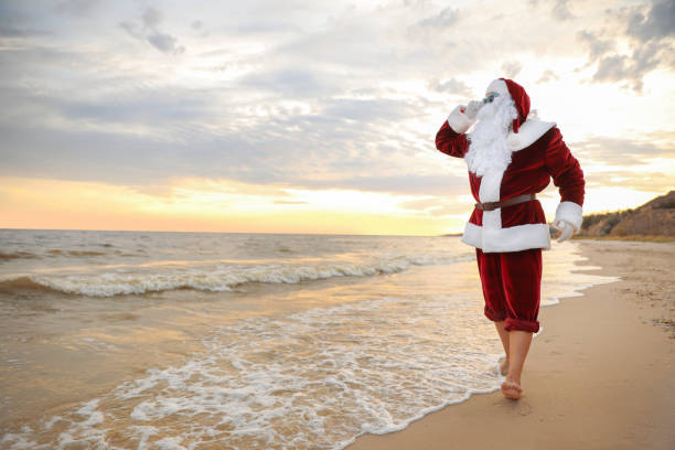 istock Santa Claus on beach, space for text. Christmas vacation 1365679100