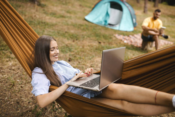 istock Young couple camping in forest 1365680550