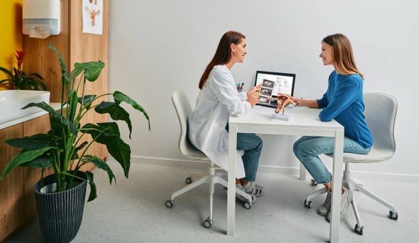 Gynecology, consultation of gynecologist. Gynecologist consulting a woman patient, talking about women's health and diseases of uterus and ovaries stock photo