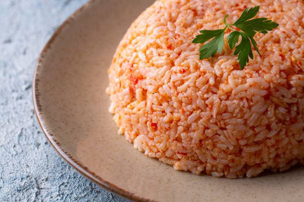 Traditional delicious Turkish food; rice pilaf with tomatoes (Turkish name; Domatesli pirinc pilavi) Traditional delicious Turkish food; rice pilaf with tomatoes (Turkish name; Domatesli pirinc pilavi) pilau rice stock pictures, royalty-free photos & images